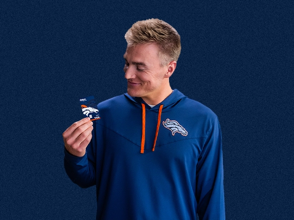 Box Nix in a Broncos hoodie holding a debit card
