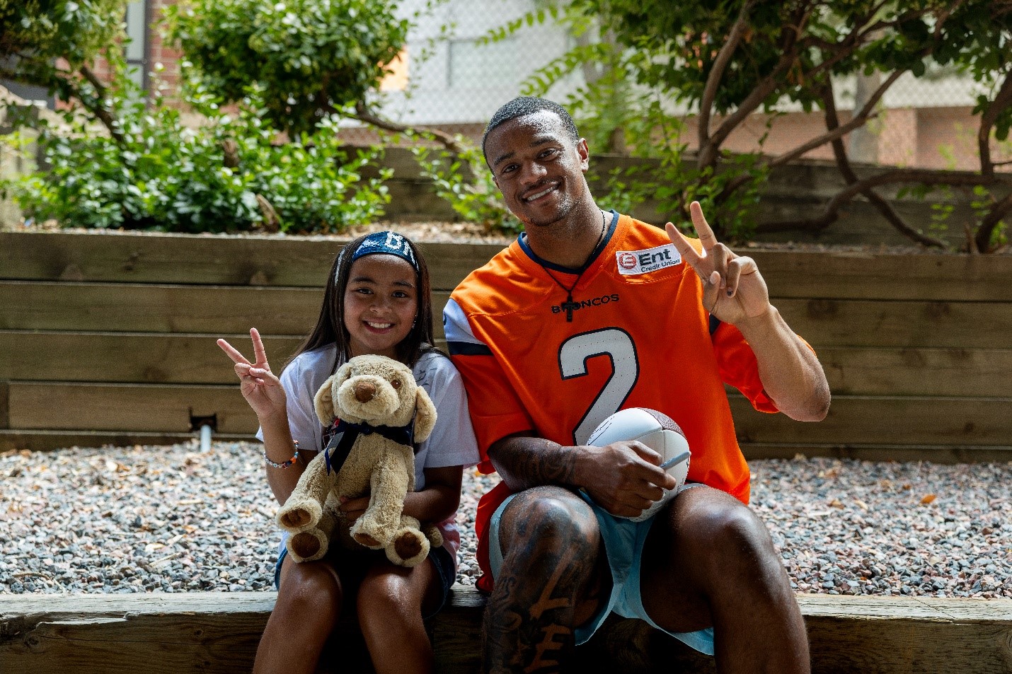 Photo of Pat Surtain II and Liv, a Children’s Hospital Colorado patient ambassador.