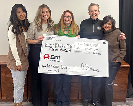 Ent employees presenting a check to the winner