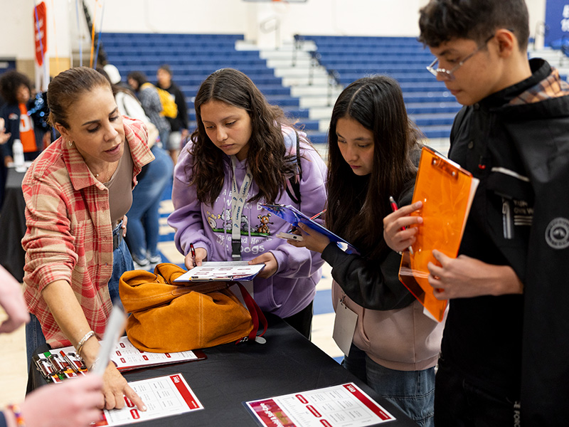 Students visiting a booth to learn more