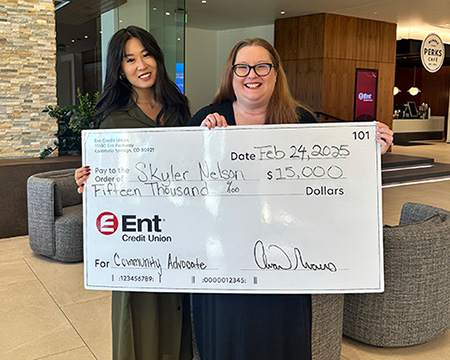 Ent employees presenting a check to the winner