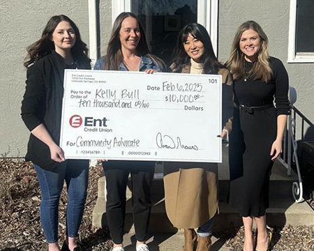 Ent employees presenting a check to the winner