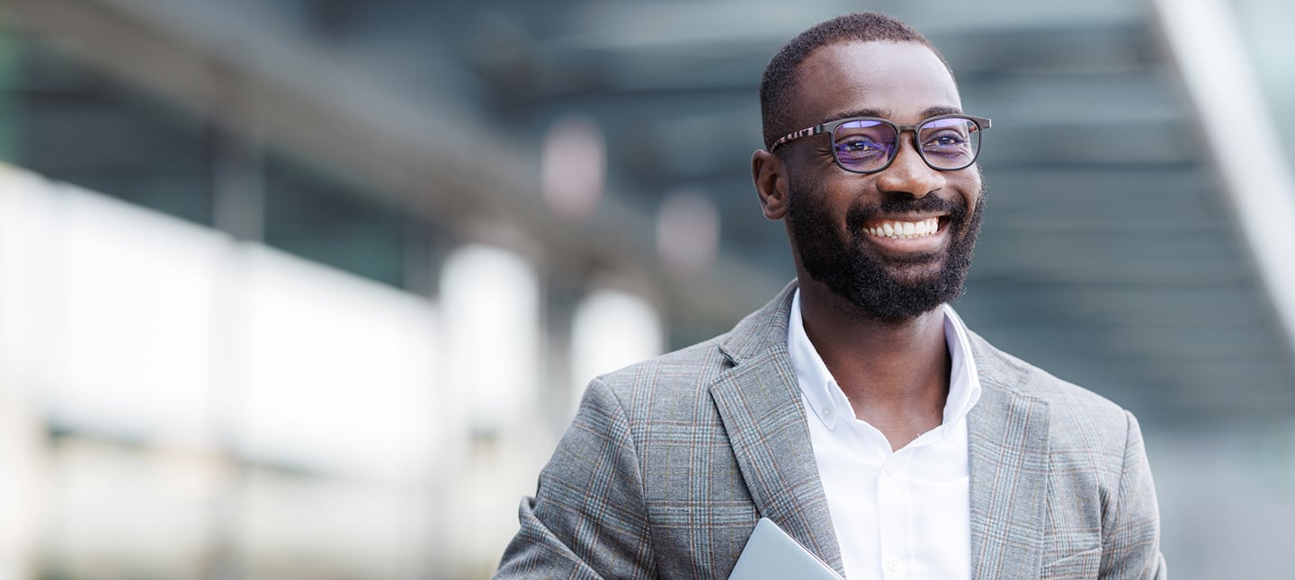 Mid-thirties African American man wearing glasses smiling.