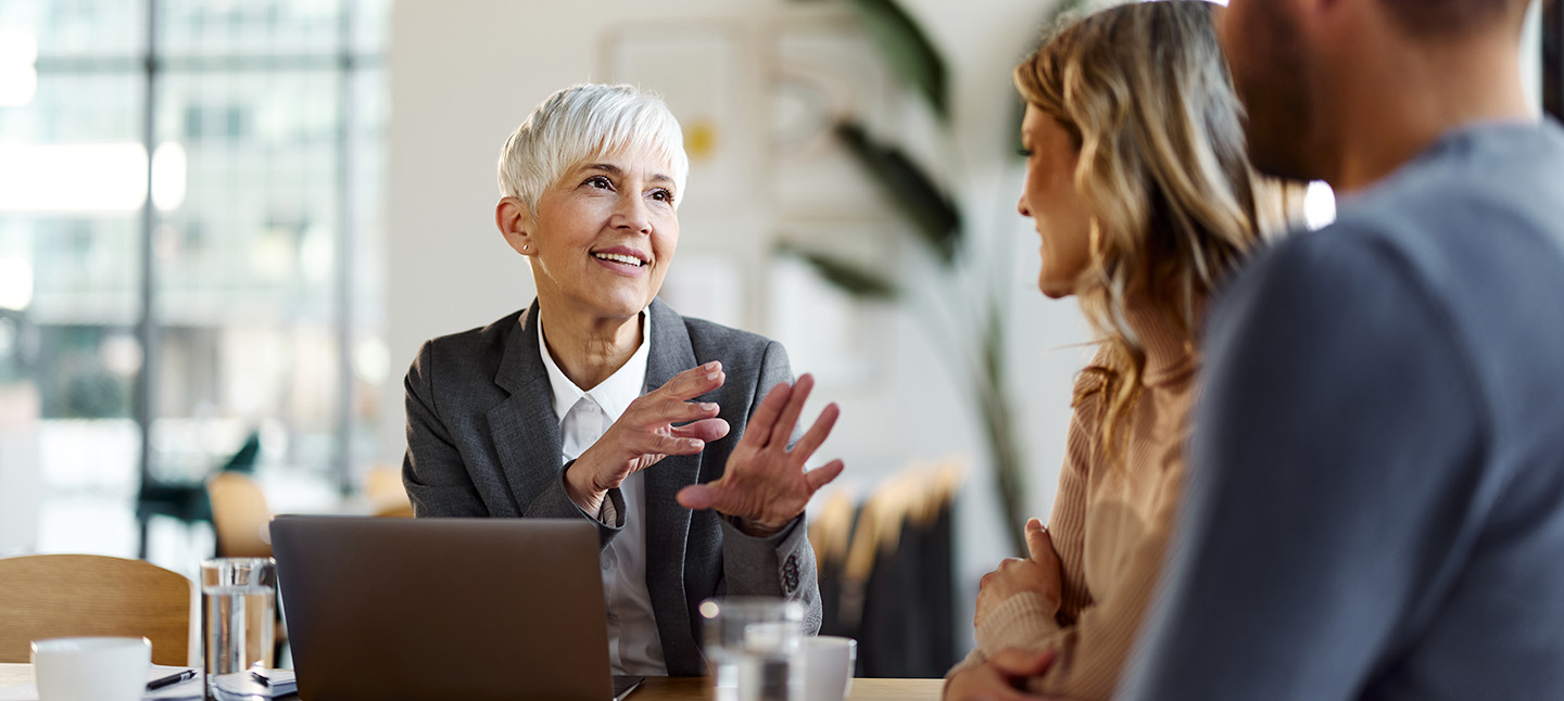 Professional women talking with couple