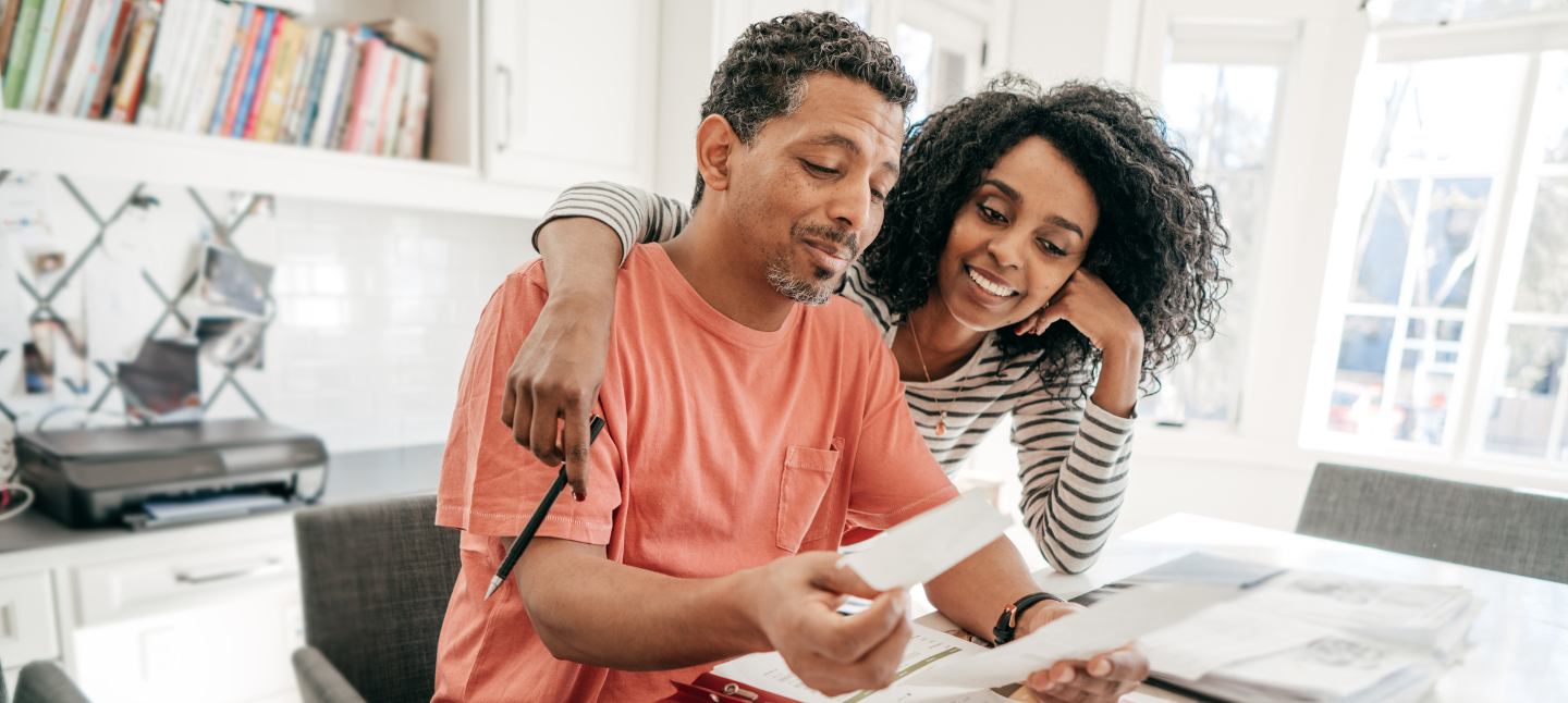 Couple and their financial planning in the kitchen with laptop