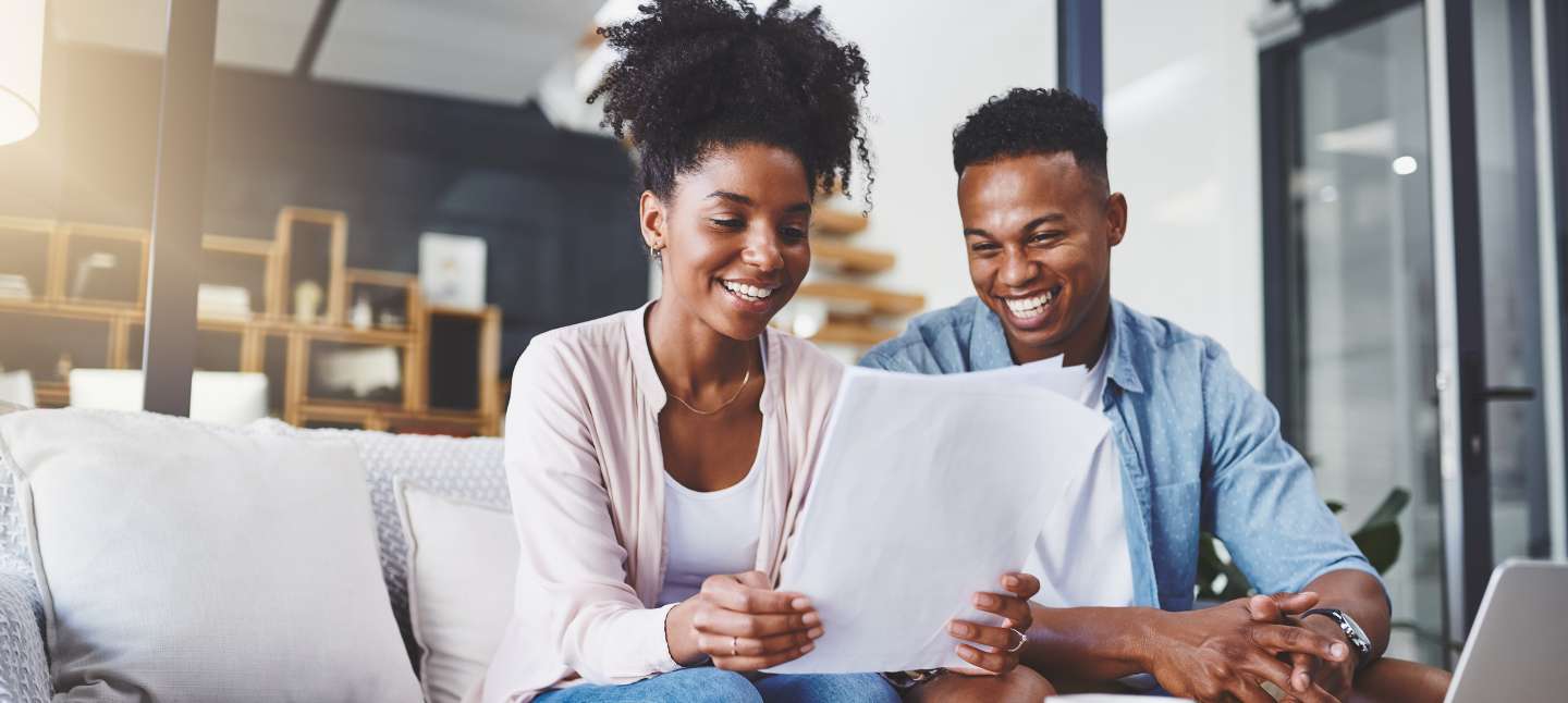 Shot of a young couple going through their paperwork together at home.