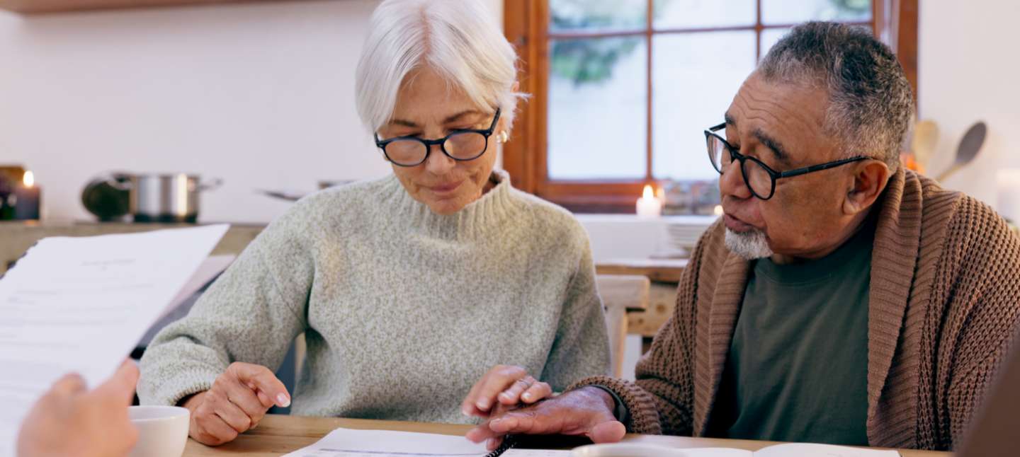 Senior couple sitting and reviewing paperwork