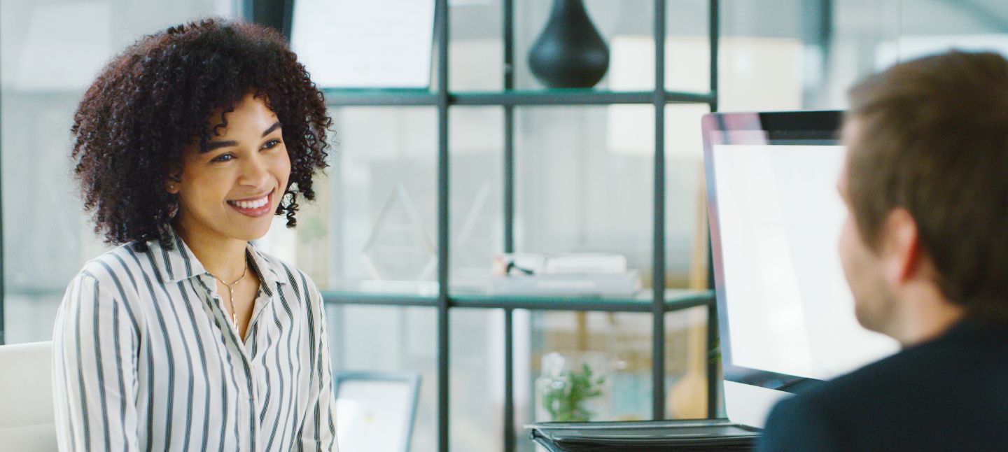 Middle age woman at a office smiling