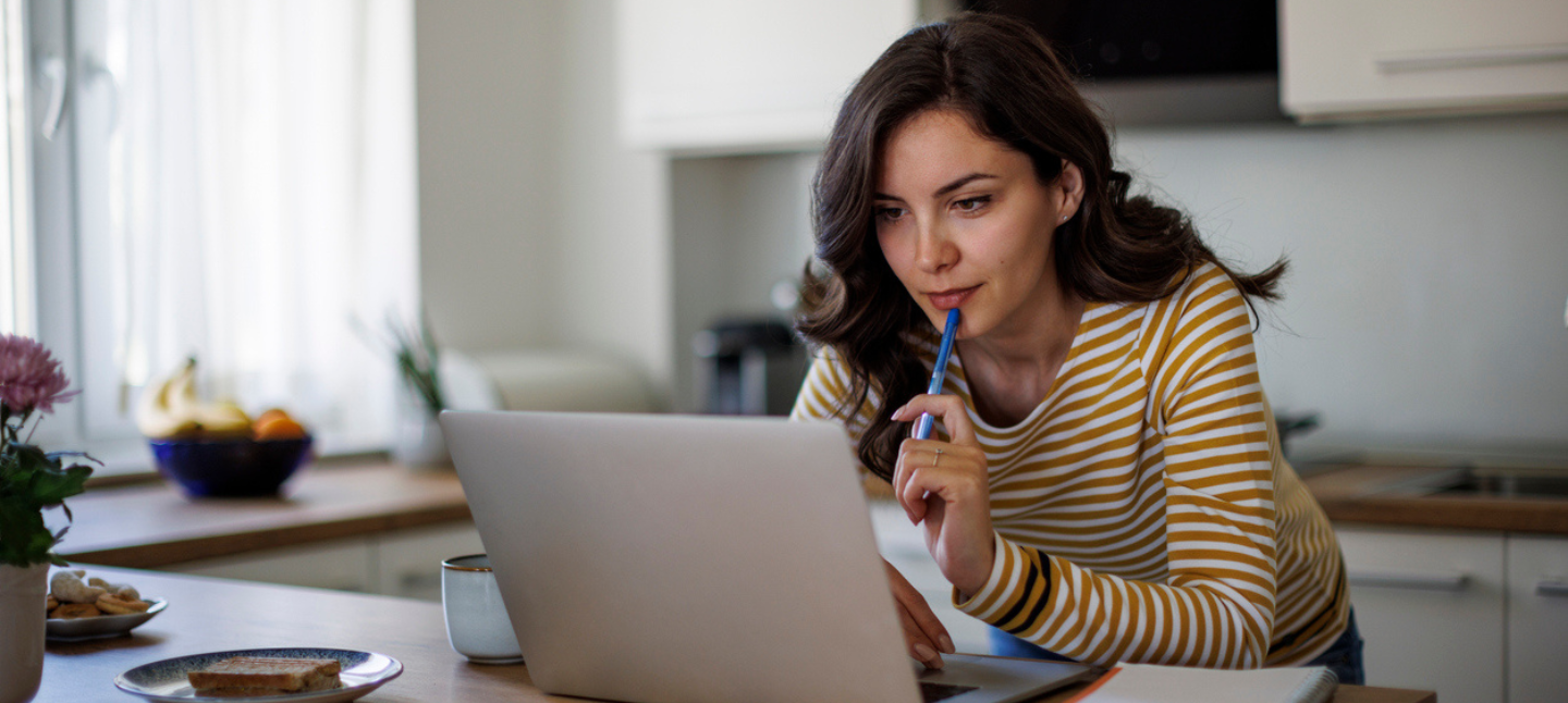 A woman sitting at a desk using her laptop