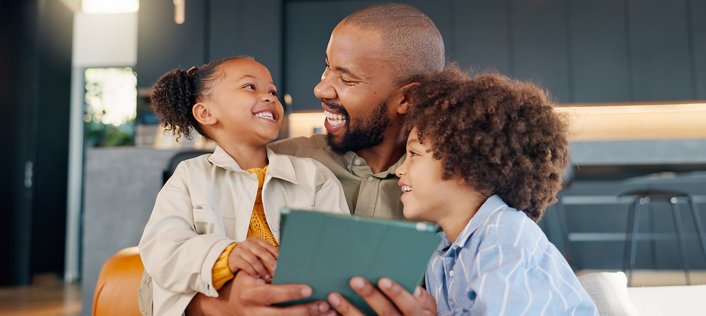 Family in the living room for laughing with a tablet