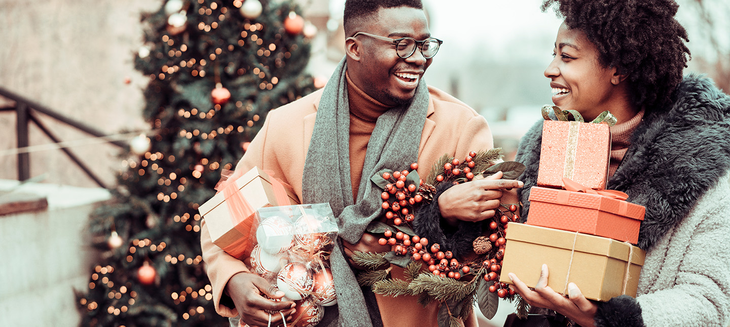 Young couple at Christmas shopping, holding Christmas present's