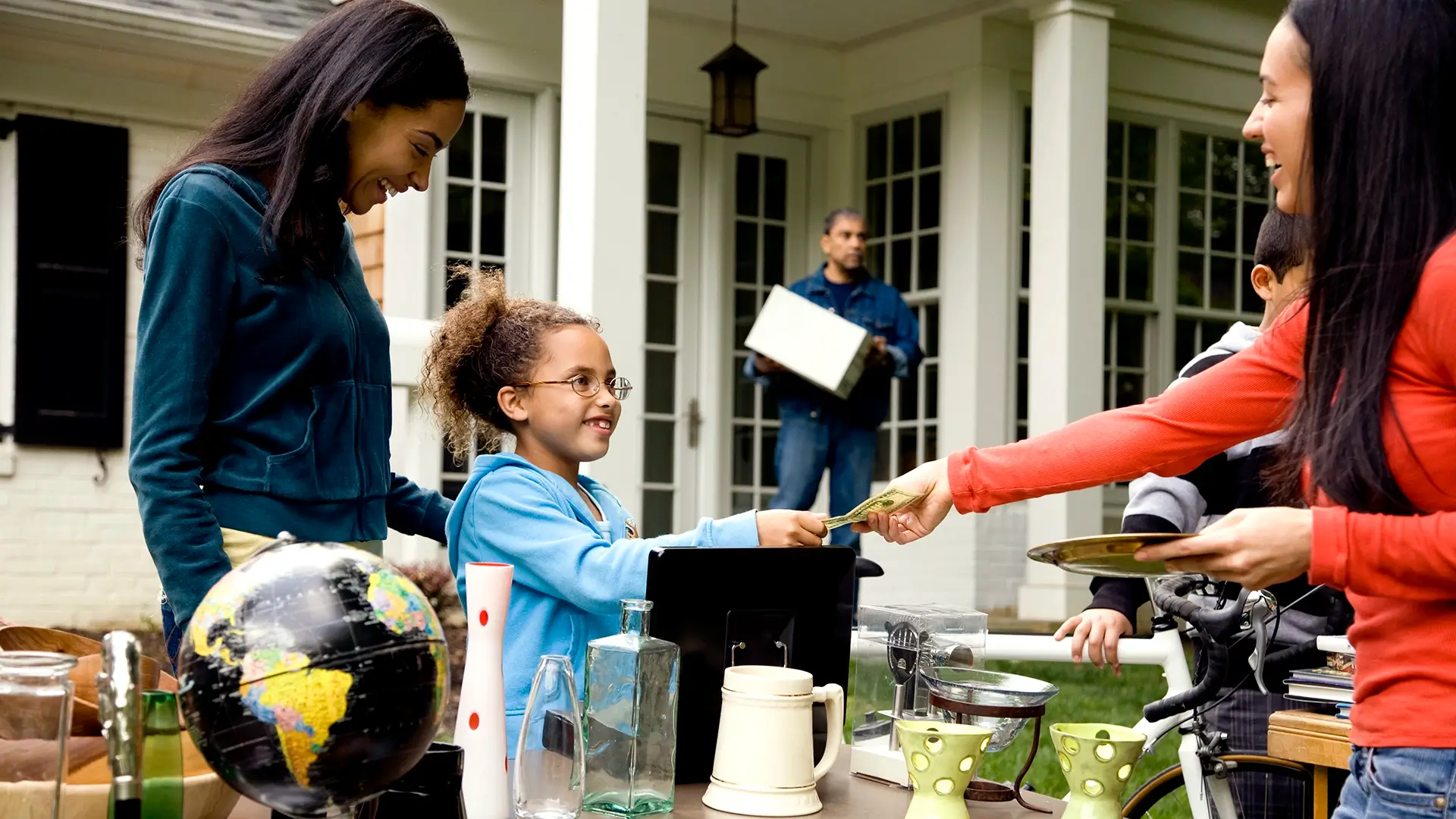 Woman buying item at a yard sale