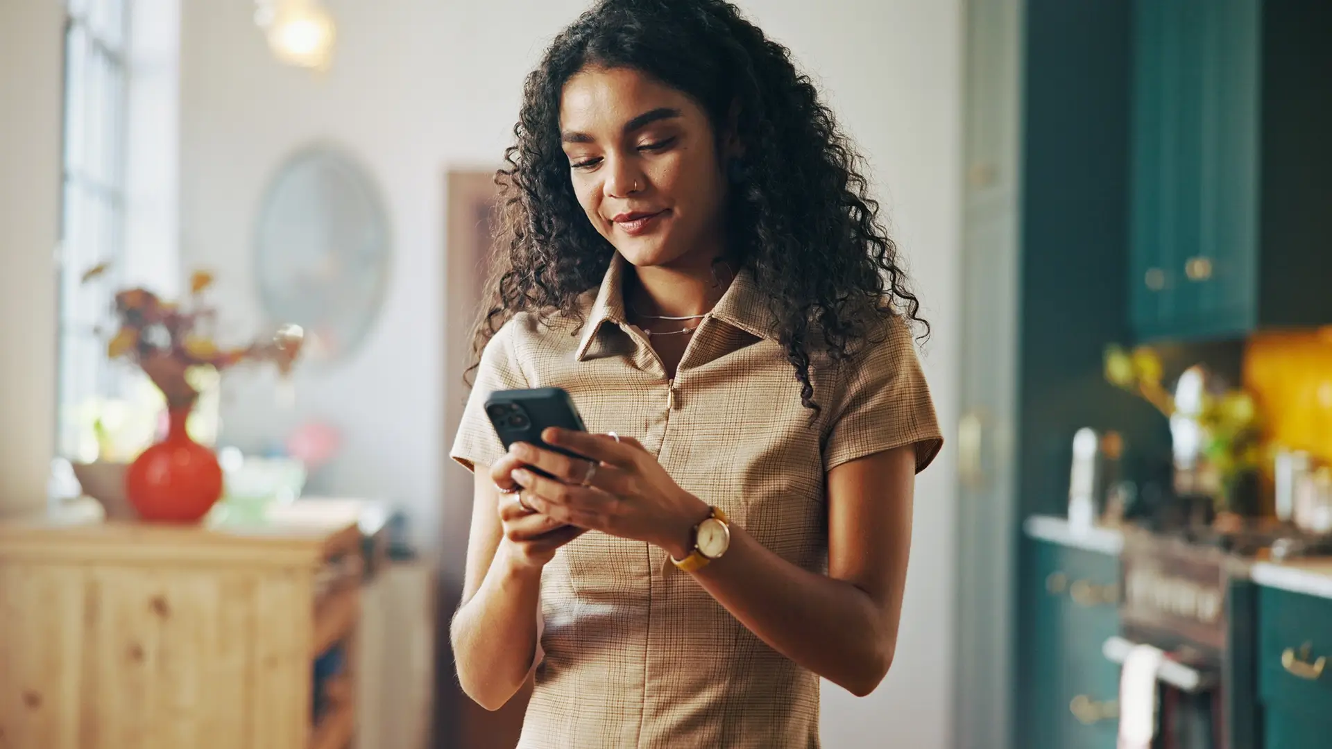 A young woman at home using her phone to look at her subscriptions