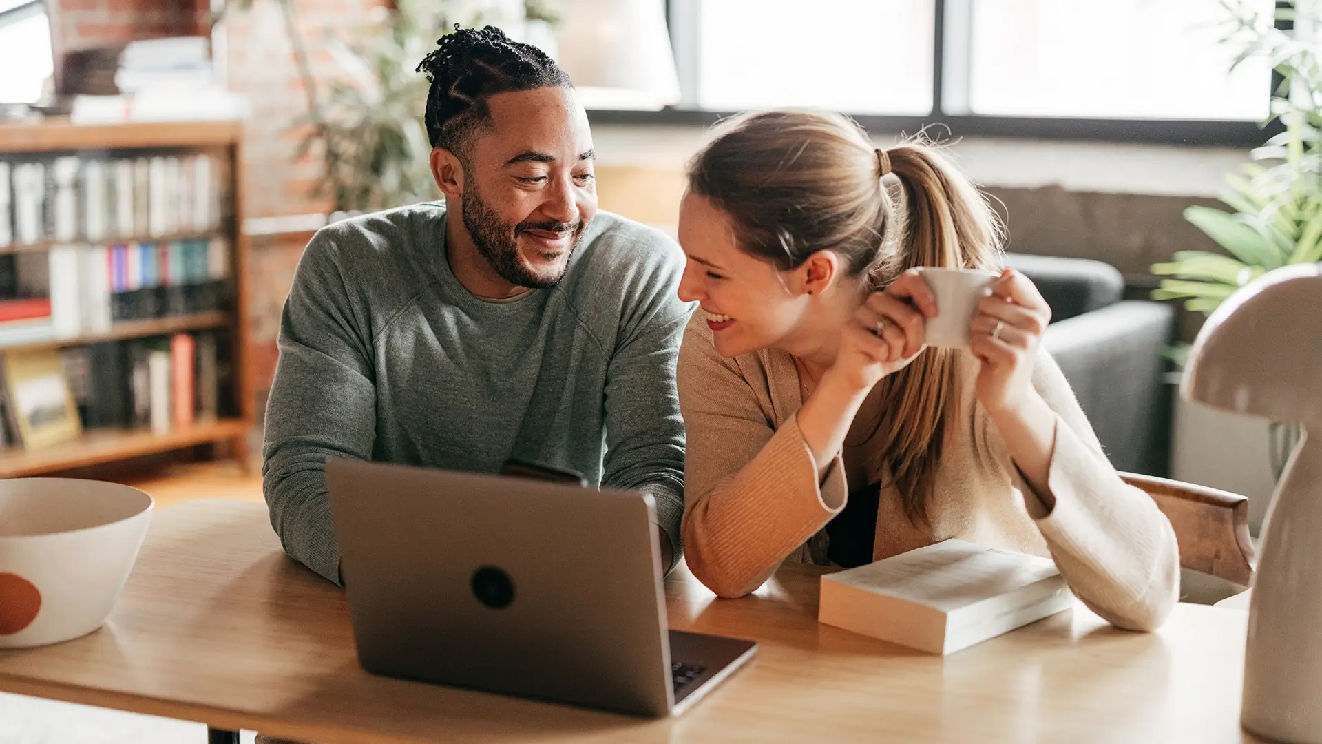 A couple at home sitting at their kitchen table having a conversation