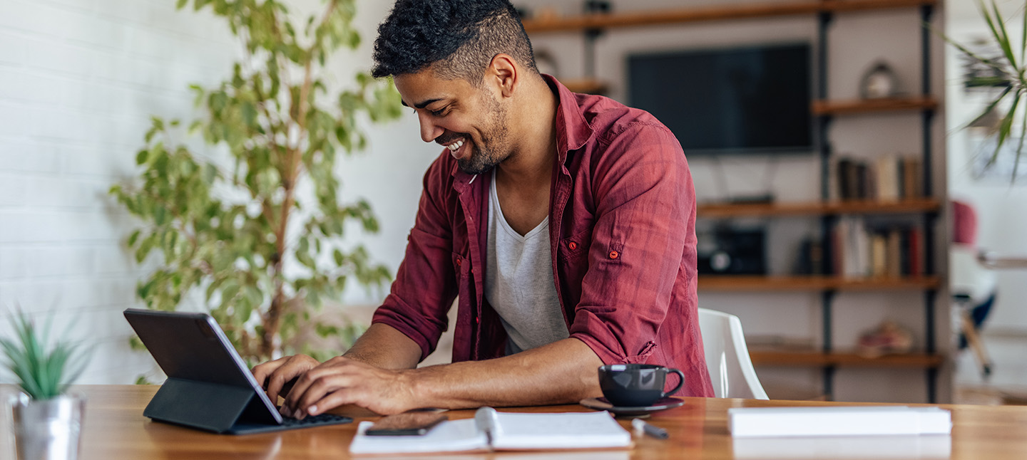 Adult man typing on his laptop
