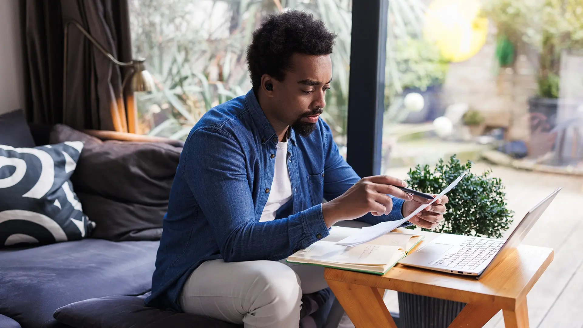 A man at home working and analyzing documents