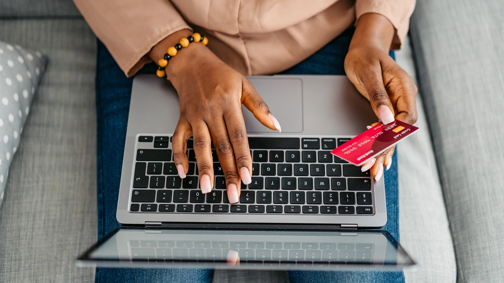 A woman on her laptop buying something with a credit card