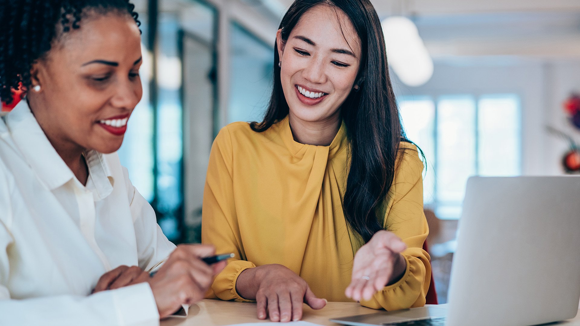 Two women talking about business