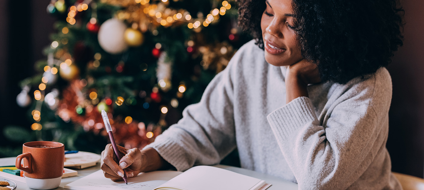 A Happy Beautiful Woman Relaxing At Home Near Christmas Tree