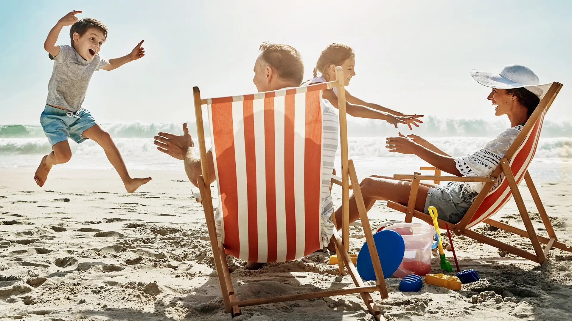 A family playing in the sand on a beach