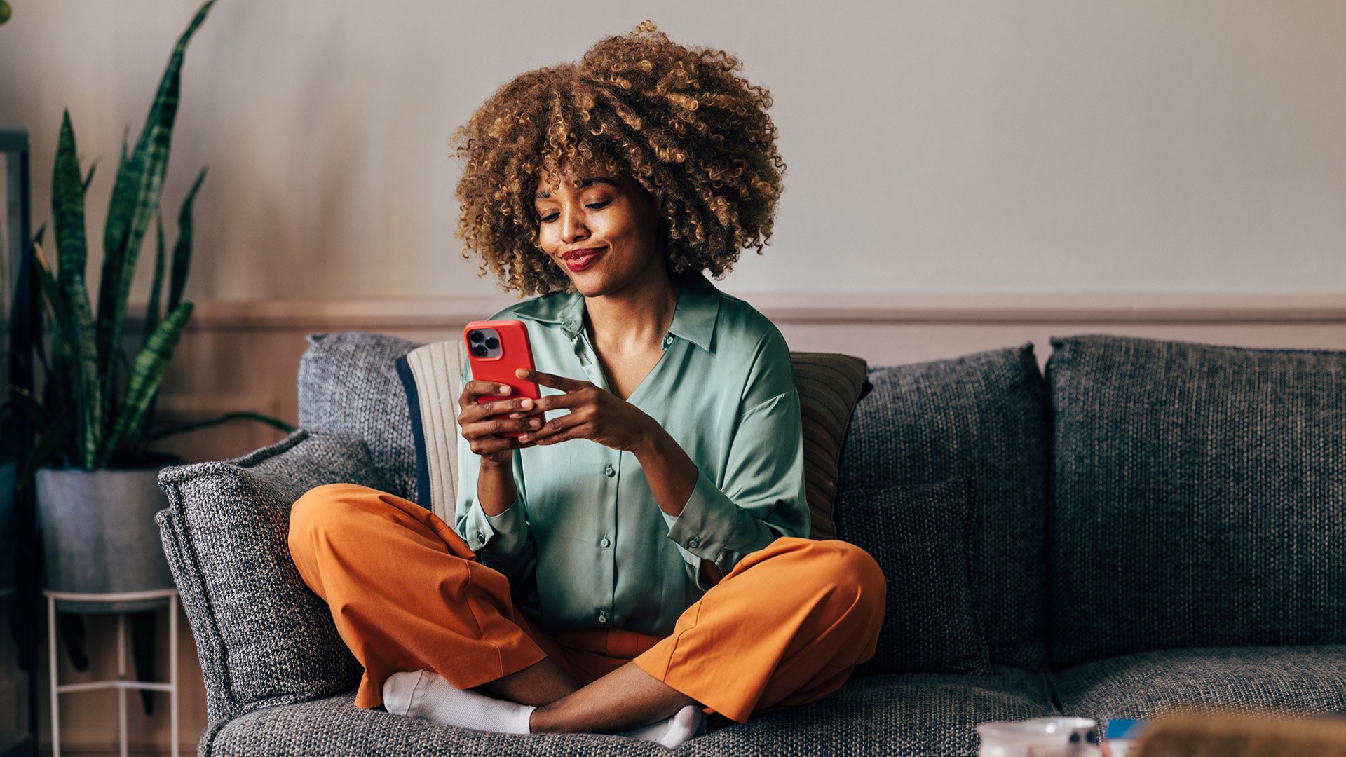 A young woman at home on her couch